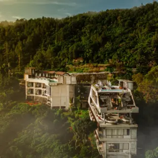 We've spotlighted @desa.o.c.u.l.u.s — and it might just be the most compelling reason to rethink your next Bali escape.

Desa Oculus, Kintamani — Bali, but not as you know it.

Perched on the Kedisan Ridge at 1,500m, this is a hotel built around a volcano, not despite one. Two terraced structures climb the mountainside — sleep at the base, dine above that, and at the peak: Ruang Langit, an open-air platform framed by Mount Batur itself.

Every room. Every window. Every aperture. Oriented strictly north — kaja, the sacred direction in Balinese cosmology. This isn't a view. It's an act of devotion, cast in concrete.

The mountain doesn't always show itself — it reveals at sunrise, in the quiet hour after rain. So you slow down. You layer up. You look longer.

Bali rarely asks this of you. That's the point. 

Full story live on Lux Nomade — link in bio.